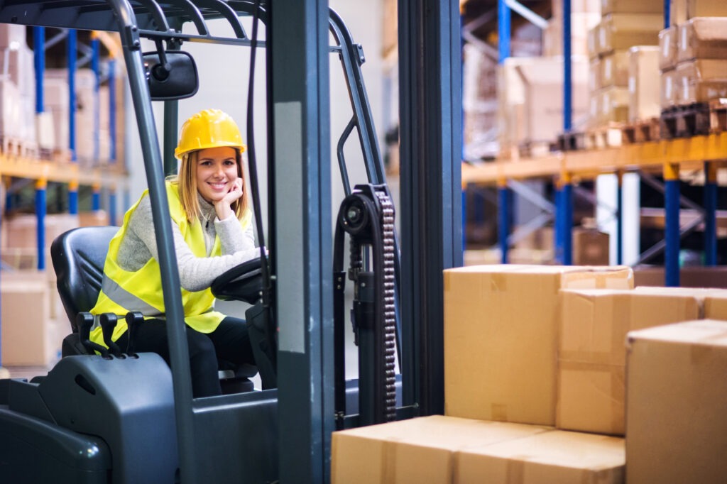 woman warehouse worker with forklift